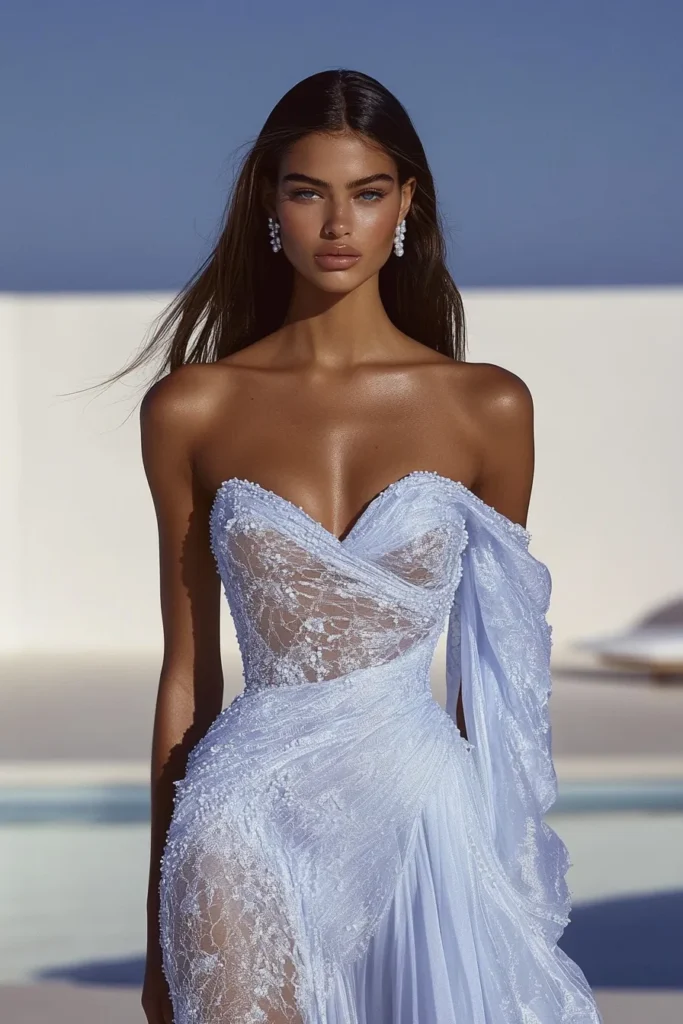 Couture-inspired lace wedding guest dress with romantic off-shoulder draping, body-contouring lace panels, and ethereal mesh accents in a serene setting