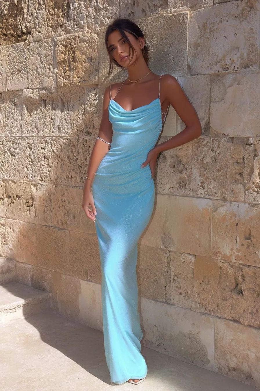 a stunning blue elegant cowl neckline, standing against stone wall architecture, showcasing perfect summer vacation outfits for luxury resort destinations and Mediterranean travel