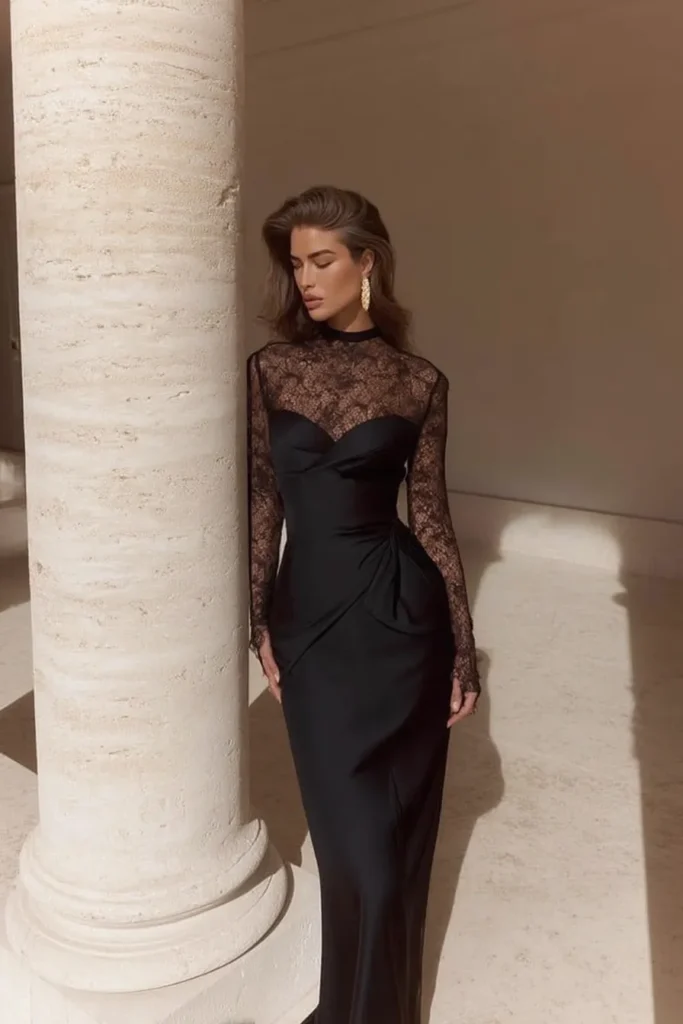Chic black fall wedding guest dress with sheer lace long sleeves, elegant high neckline, lace panel, statement gold earrings for sophisticated fall wedding guest attire