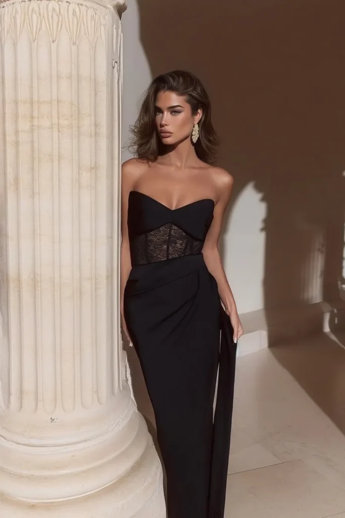 Elegant black dress for wedding guest occasions with strapless sweetheart neckline with lace panel detailing, figure-hugging silhouette, floor-length design perfect for fall formal events
