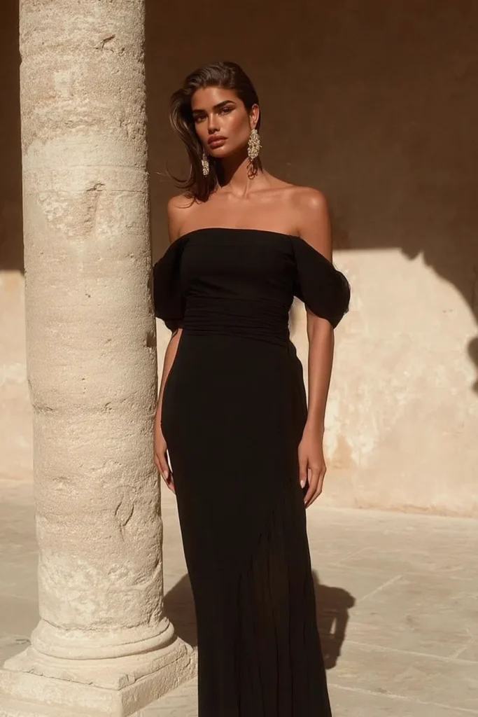 Luxurious cocktail dress wedding guest design with off-shoulder sweetheart bodice, elegant short sleeves, form-fitting silhouette, and timeless black styling for formal occasions.