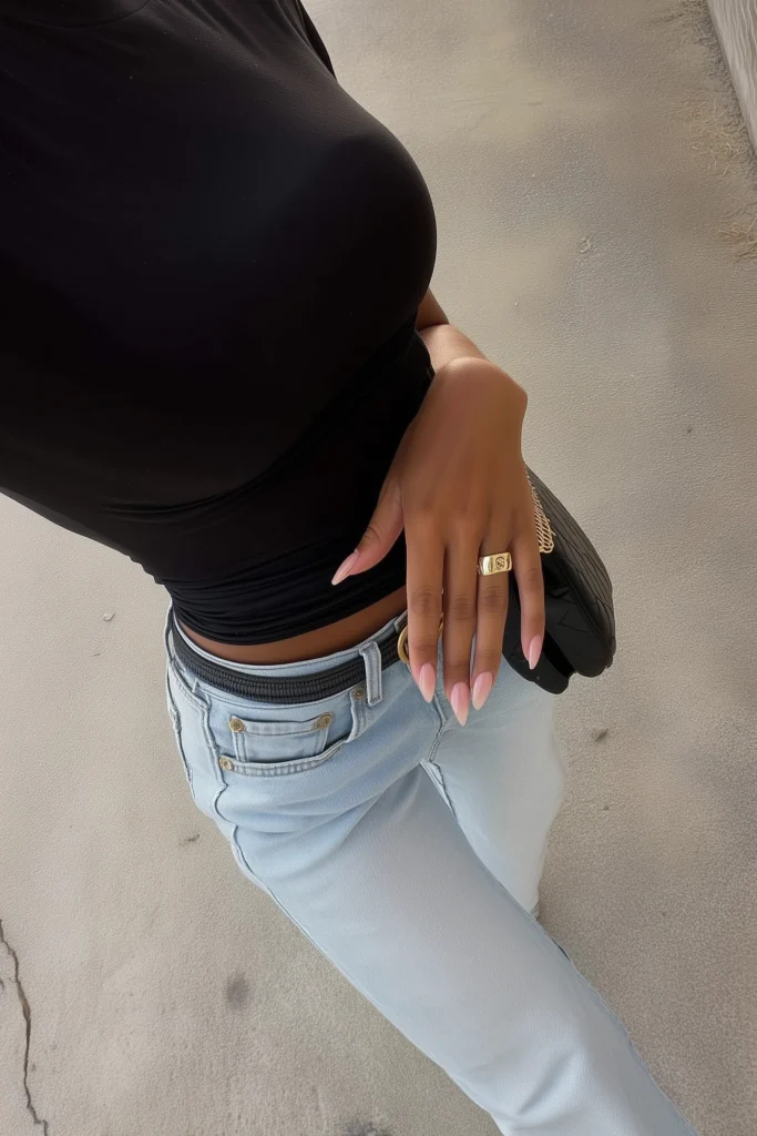 Casual fall outfits for women with black top styled with high-waisted straight-leg blue jeans, accessorized with black bag and black pointed-toe heels for effortless autumn styling