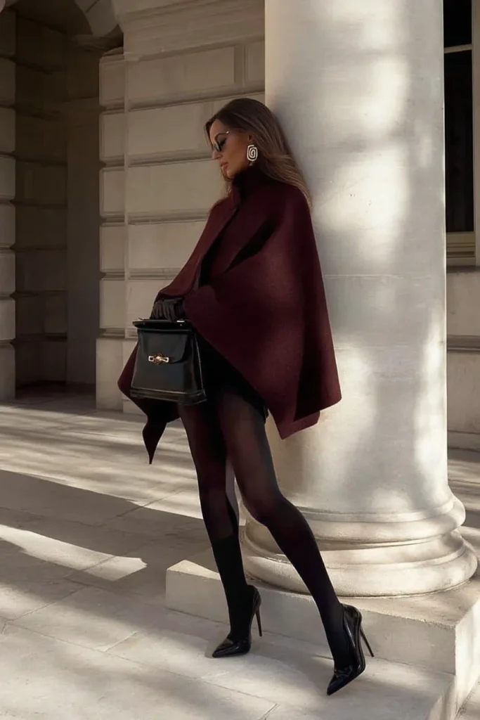 Chic winter outfits aesthetic, rich burgundy coat with black tights and glossy pumps, sleek accessories create stylish looks perfect for winter dressing