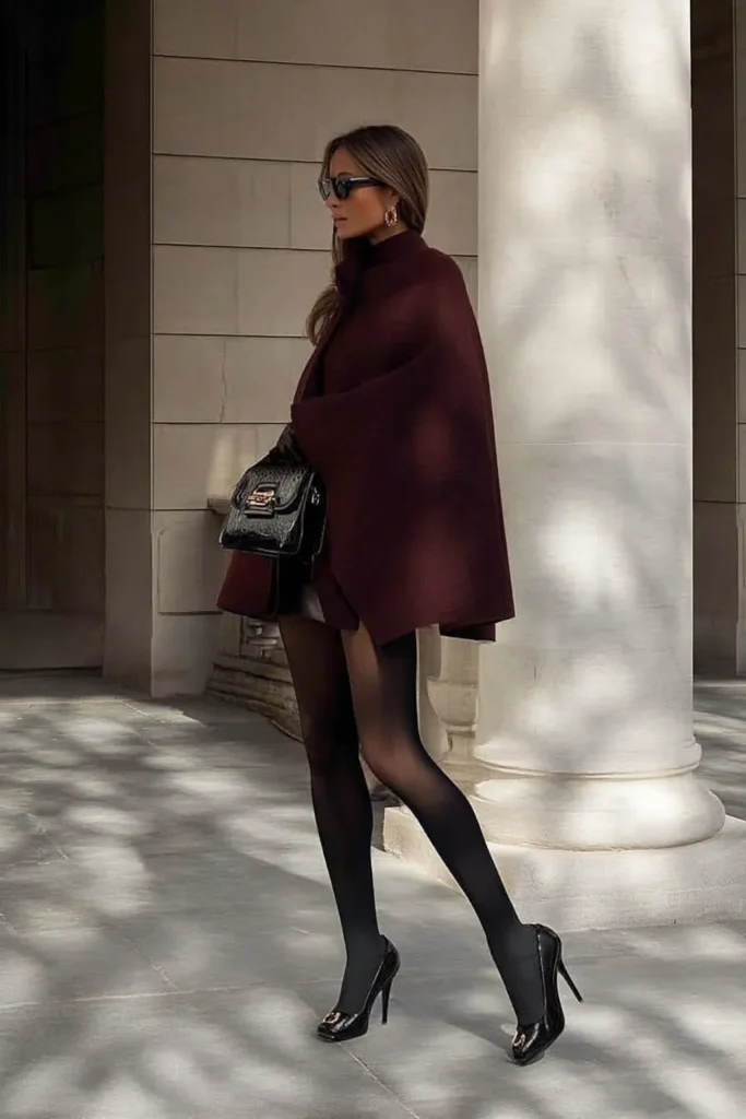 Luxurious winter outfits aesthetic, oversized burgundy wool blazer, styled with black tights, patent leather heels, and handbag, with sunglasses for elegant cold weather fashion inspiration