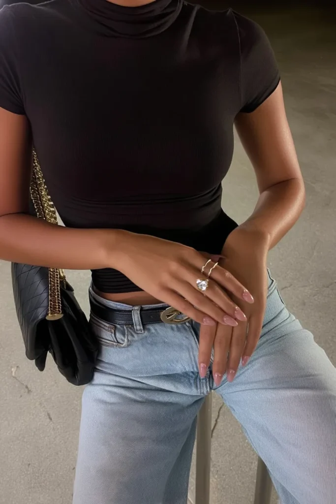 Sophisticated casual fall outfits for women with fitted black top with blue denim jeans, and black leather quilted handbag with gold hardware, for seasonal wardrobe